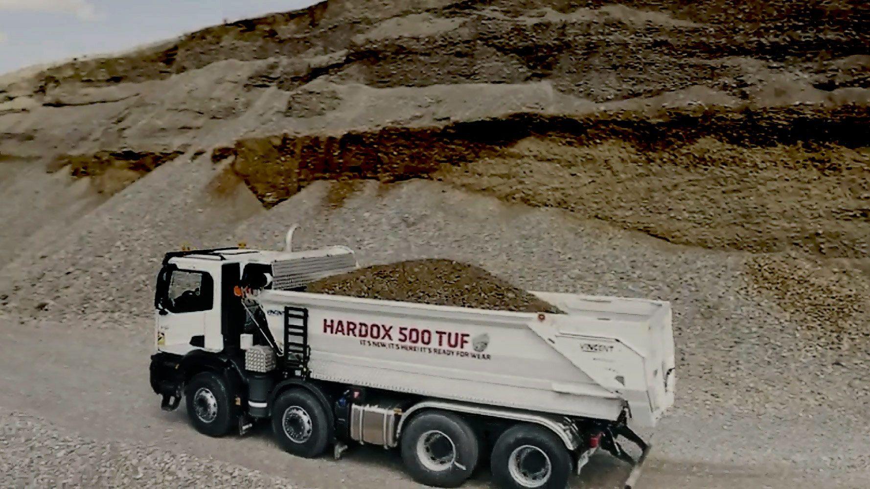 Bennes Vincent truck moving heavy load of gravel.