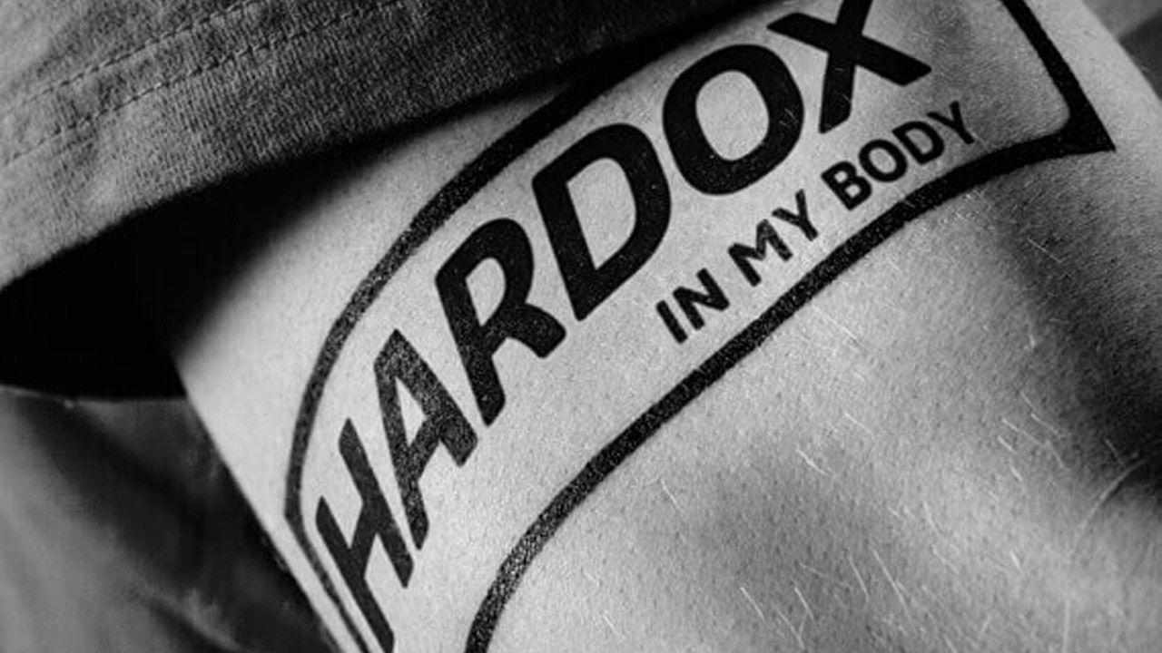 Hardox logo tattooed on an arm.